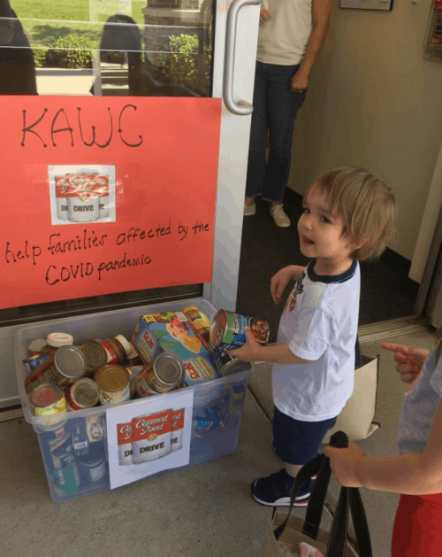 Kiddie Academy student collecting cans